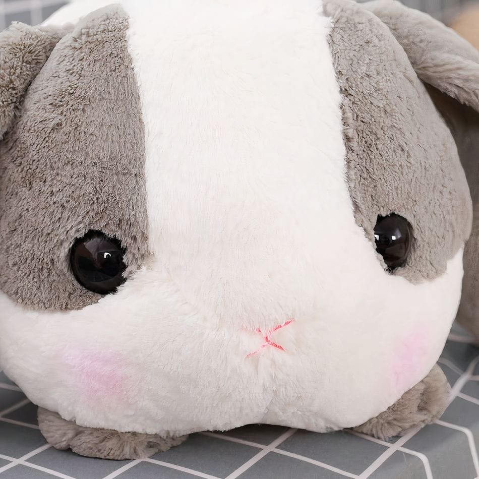 La Peluche Peluche lapin gris couché