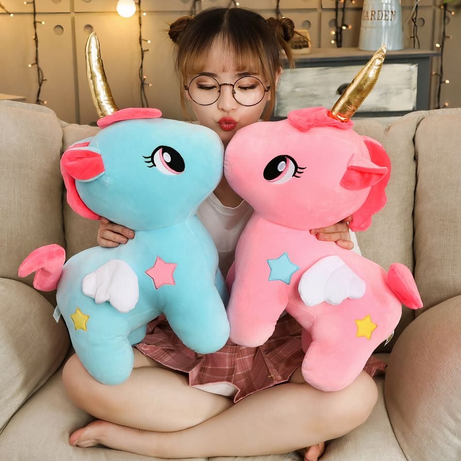 La Peluche Peluche licorne rose avec corne dorée