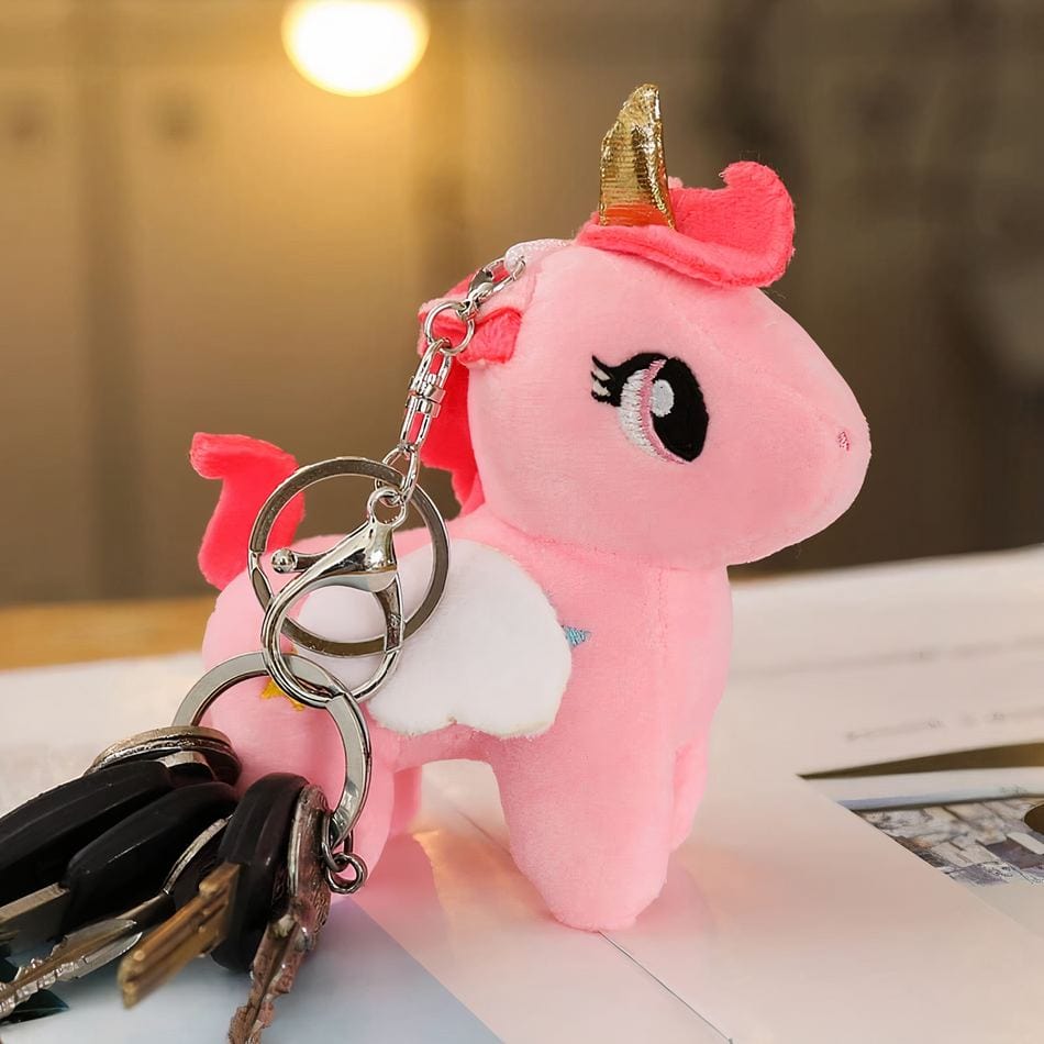 La Peluche Peluche licorne rose avec corne dorée