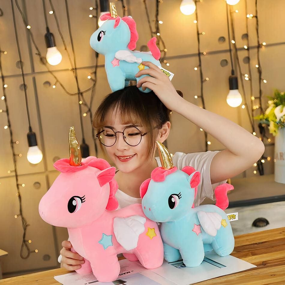 La Peluche Peluche licorne rose avec corne dorée